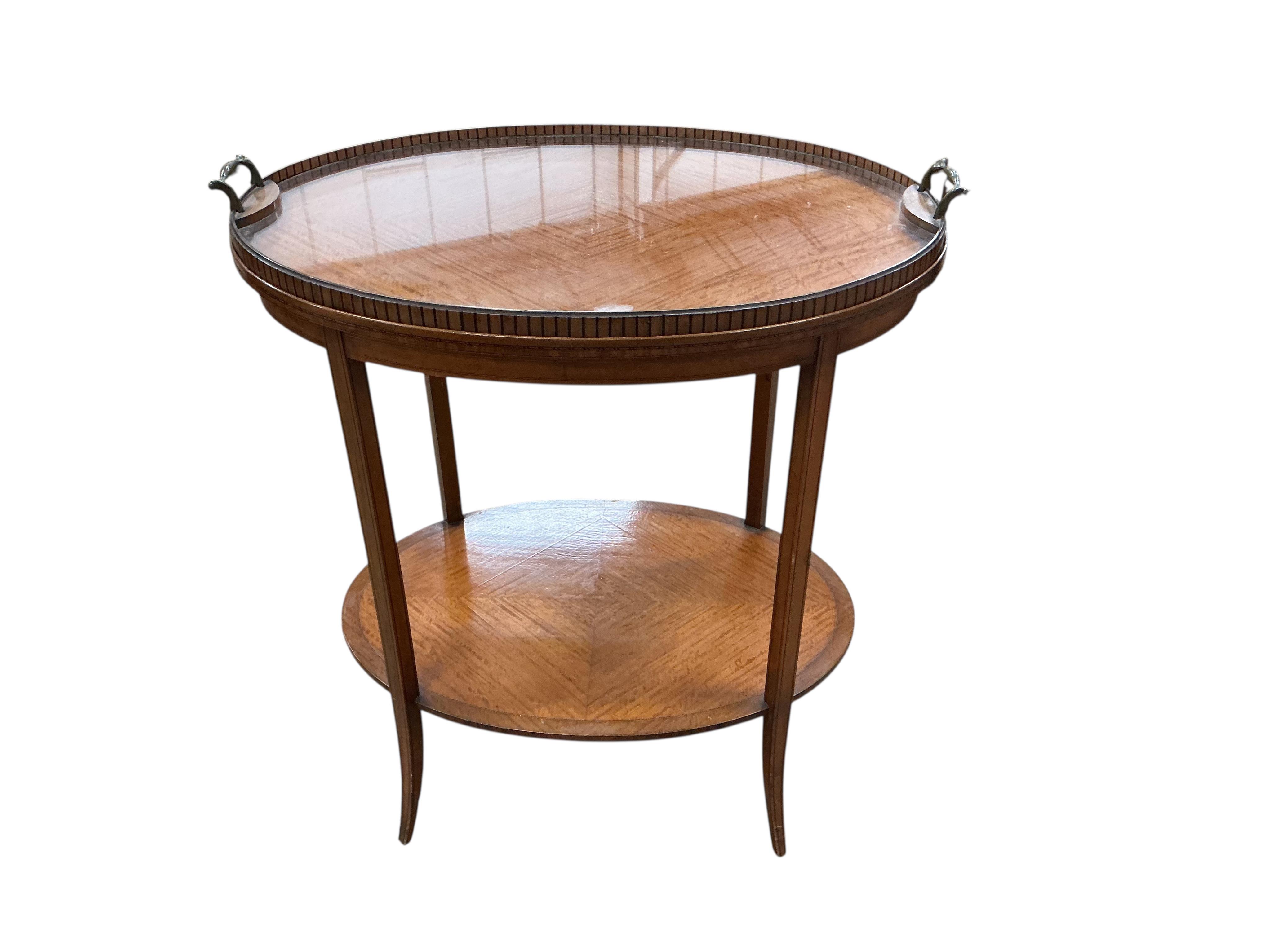 An Edwardian oval satinwood tray top etagere, width 67cm, depth 45cm, height 75cm
